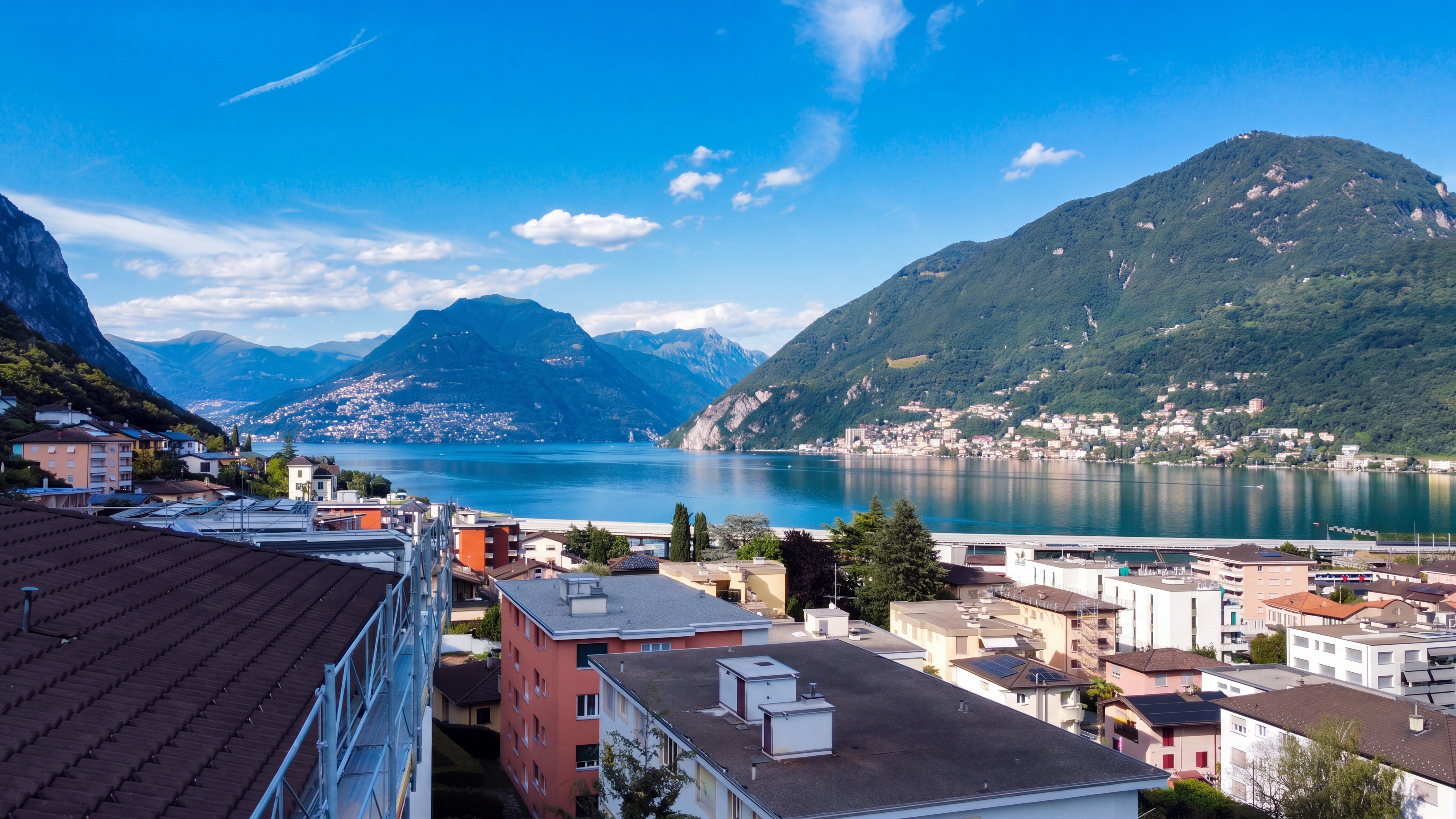 Panoramic view across the rooftops towards Lake Lugano